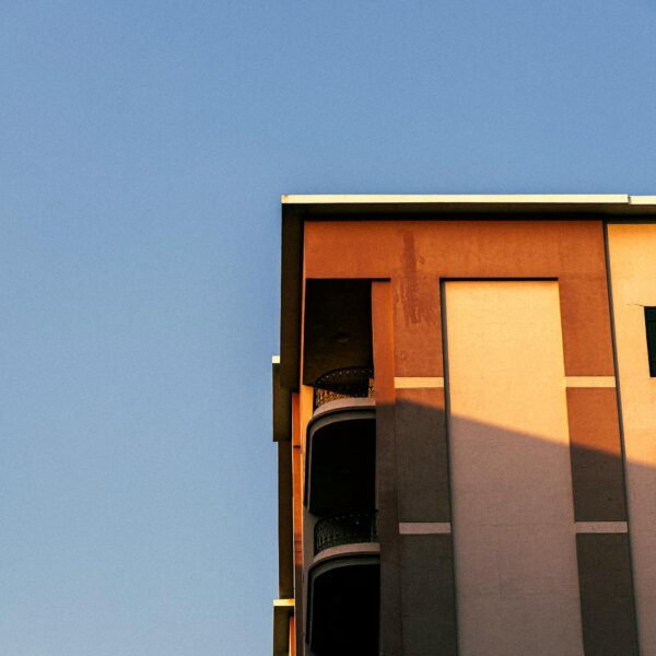 Corner view of a modern building in Dubai against a clear blue sky.