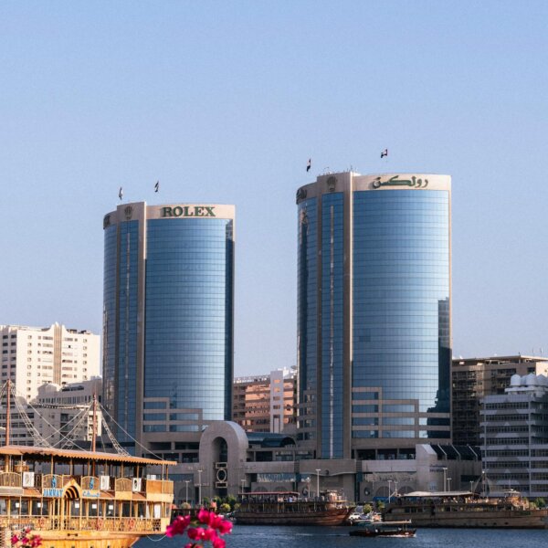 Stunning view of the Rolex Towers in Dubai against a clear blue sky, showcasing urban architecture.