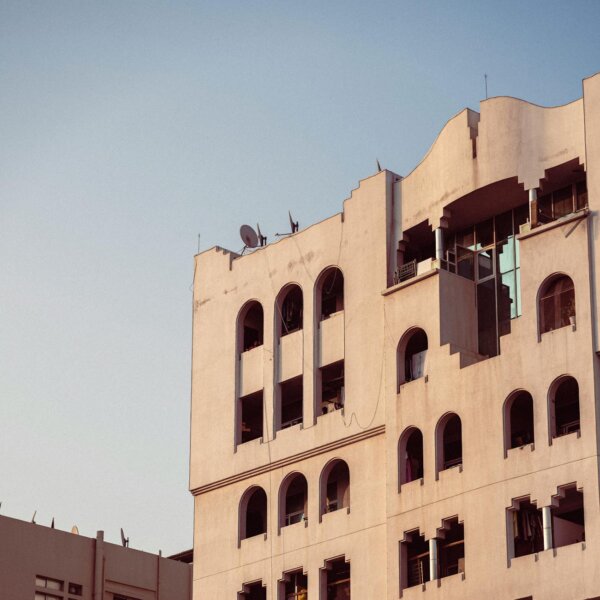 Urban architectural design of a modern building facade in Dubai under clear skies.